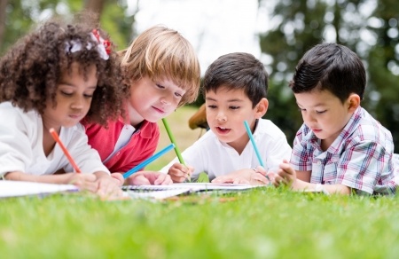 Kids writing on grass