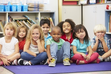 A group of children sitting in a classroom